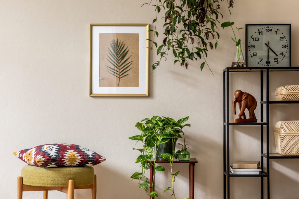 Stylish retro home staging of living room with gold mock up poster frame.